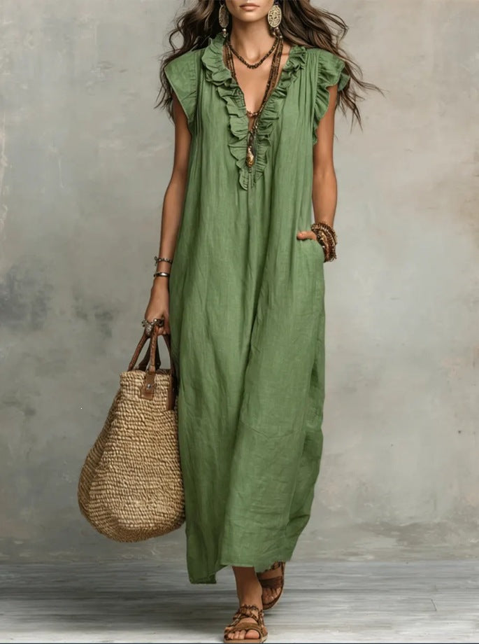 Woman wearing a green dress holding a woven bag against a neutral background