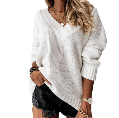 Woman wearing a white sweater and black shorts on a white background