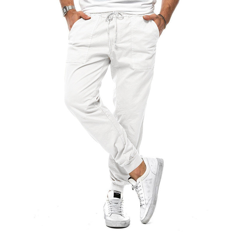 White jogger pants worn by a person on a white background