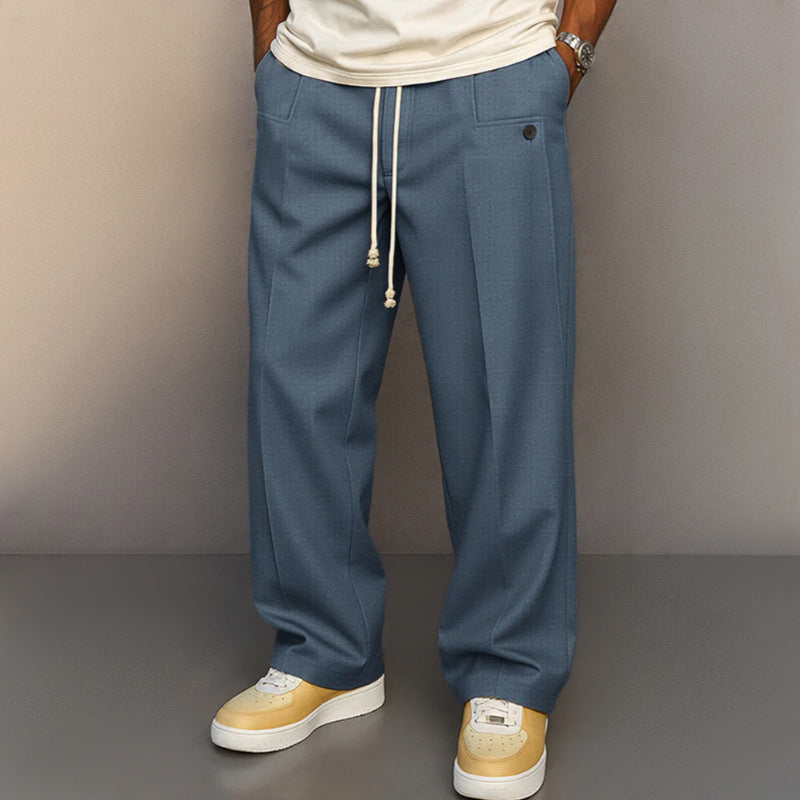 Person wearing blue pants with a plain background