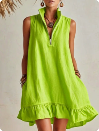 Woman wearing a bright green dress with a plain background
