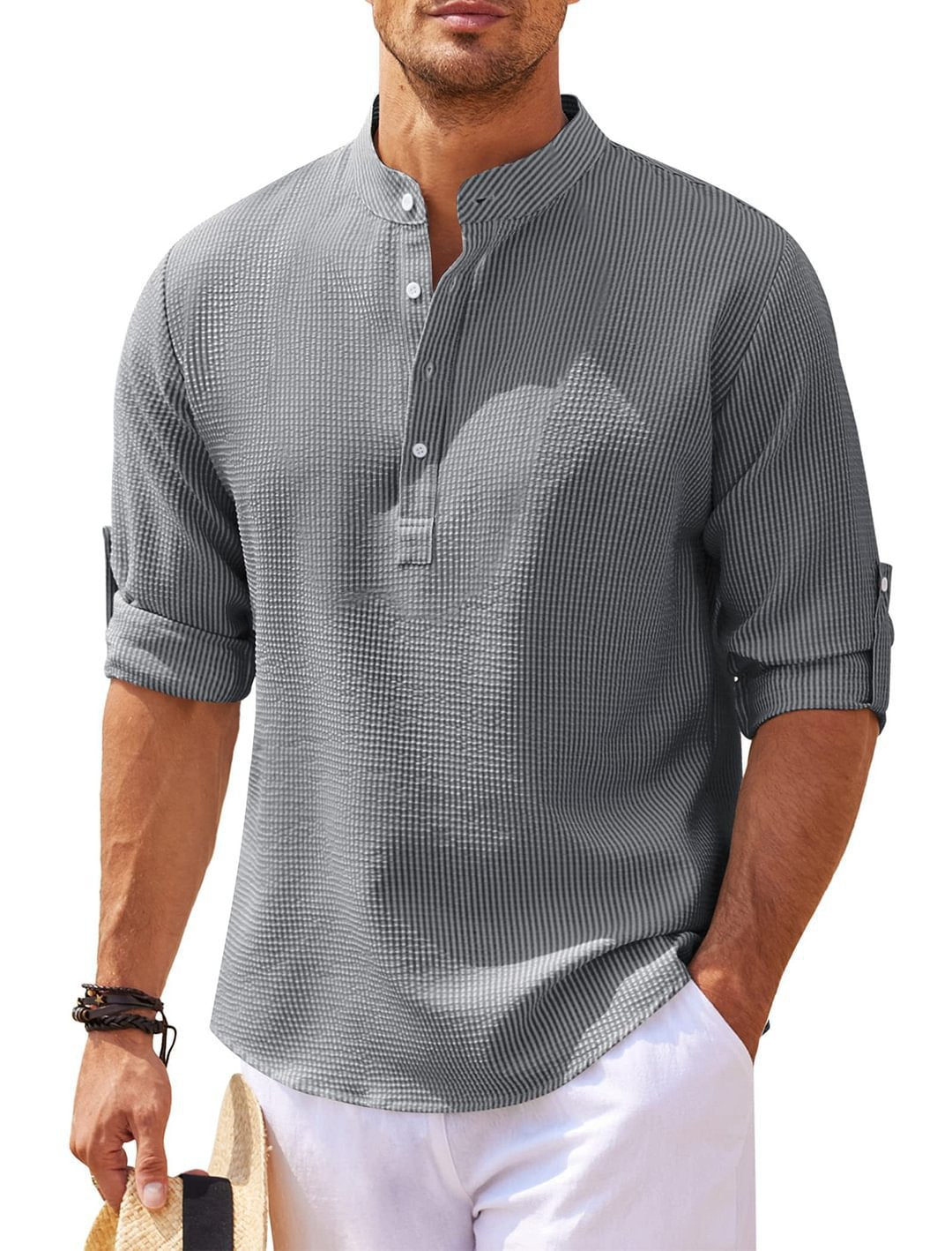 Man wearing a gray textured shirt with rolled-up sleeves on a white background