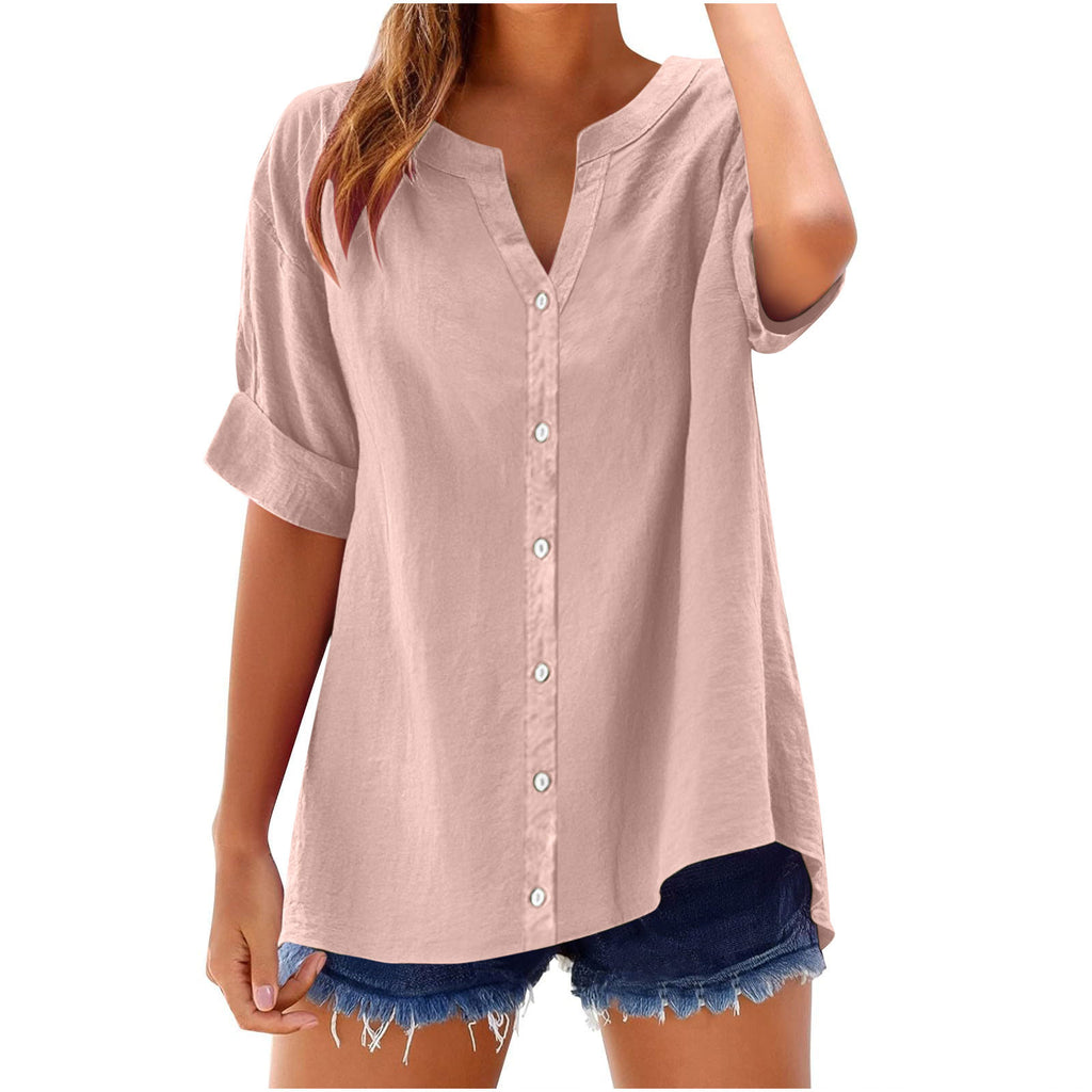 Woman wearing a light pink button-up shirt with denim shorts on a white background