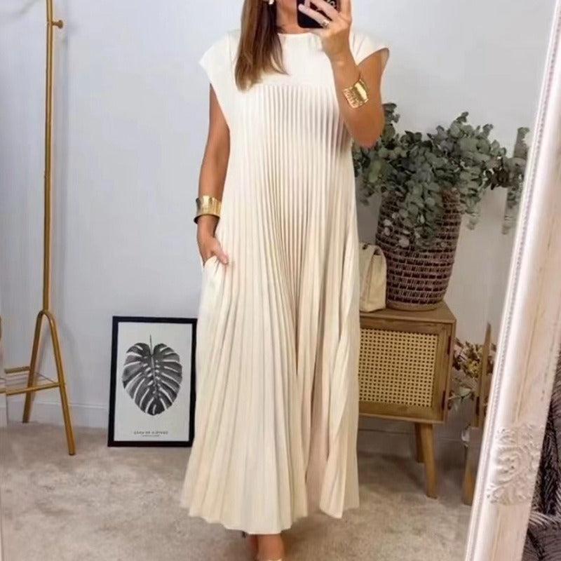 Woman wearing a long white dress taking a mirror selfie in a room with decor elements.