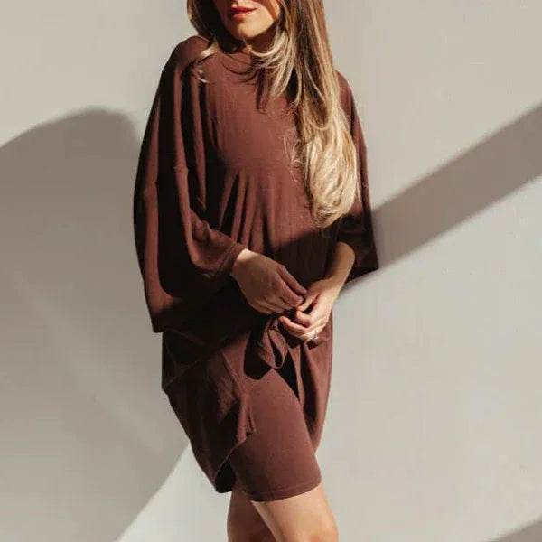 Woman wearing oversized brown shirt dress, ZA-Zola fashion, sunlight shadow on wall