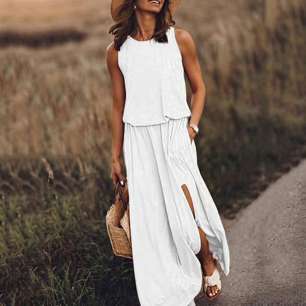 Woman in a white dress walking on a path in a field