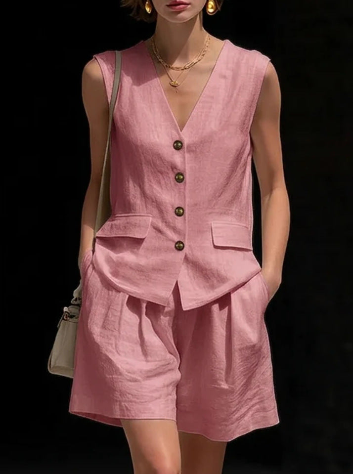 Person wearing a pink linen outfit with a black background