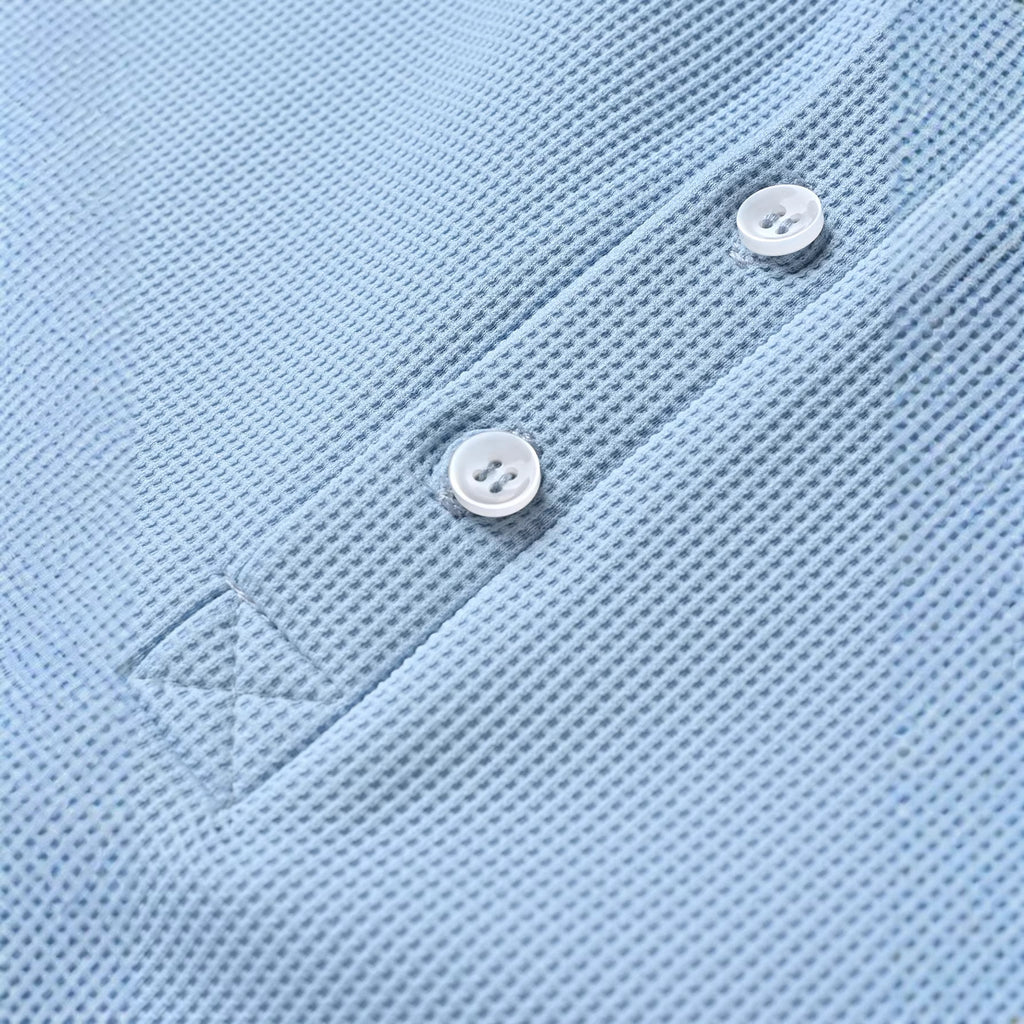 Close-up of a light blue polo shirt with buttons