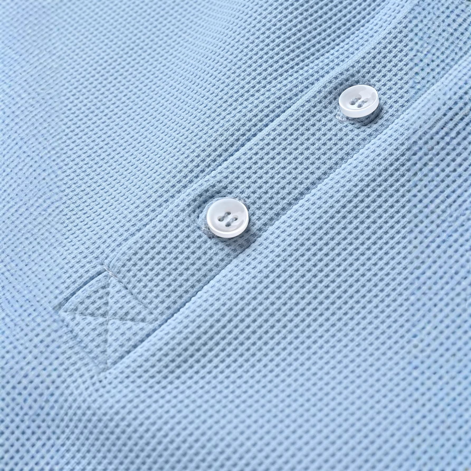 Close-up of a light blue polo shirt with buttons