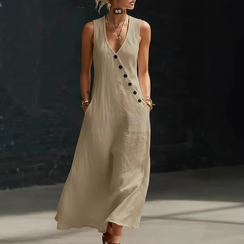 Woman wearing a beige sleeveless dress with black buttons against a dark background