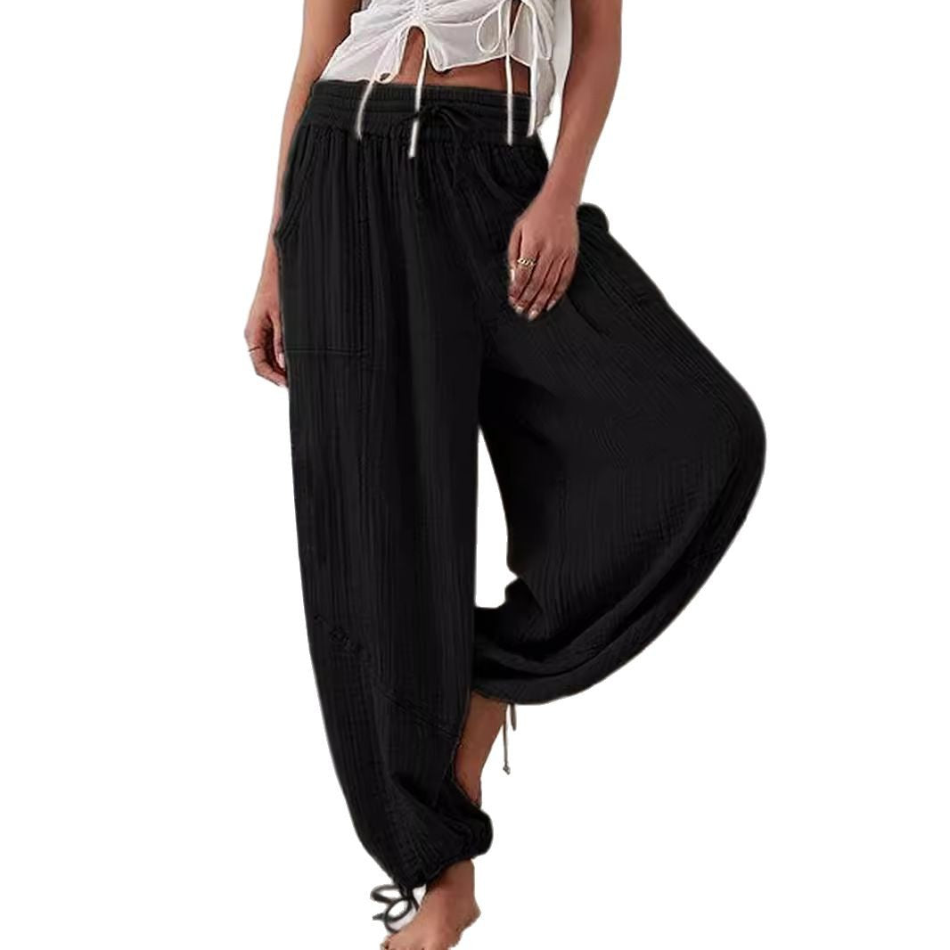 Black wide-leg pants worn by a person on a white background