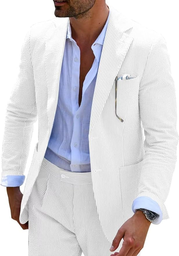 Man wearing a light-colored suit with a white shirt and striped tie.