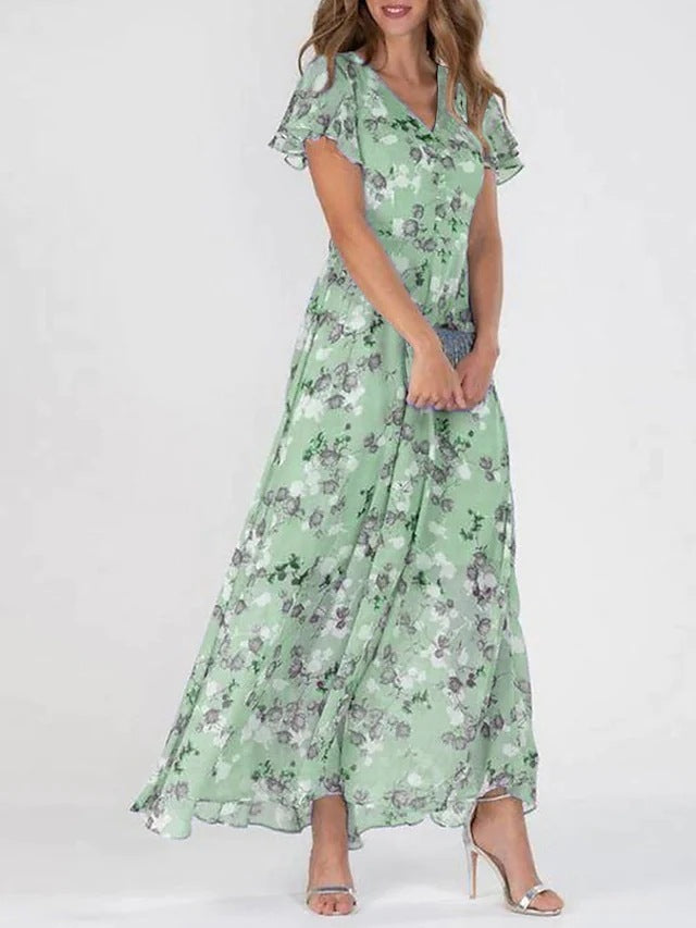 Woman wearing a green floral dress on a white background