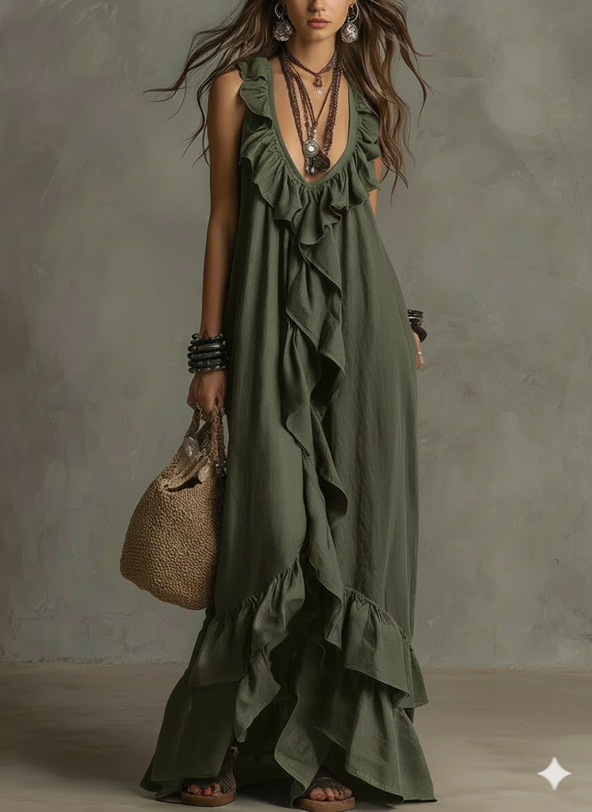 Woman wearing an olive green dress with ruffles, holding a woven bag against a neutral background.