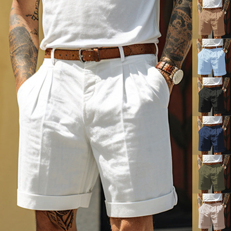 A man wearing white pleated shorts with a brown belt, shown from the waist down. The main image is larger, while a vertical strip on the right shows smaller color variants of the shorts in beige, light blue, black, navy, olive green, and light pink.