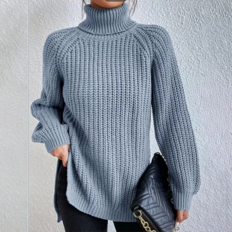 Person wearing a blue knitted sweater against a light gray background