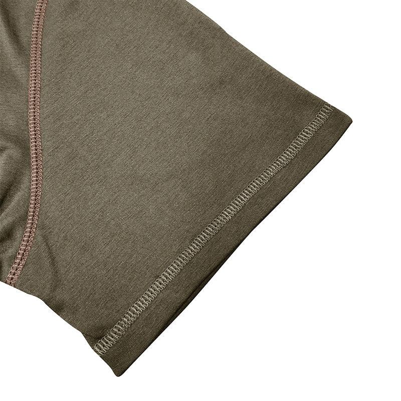 Close-up of a green fabric with visible stitching on a white background