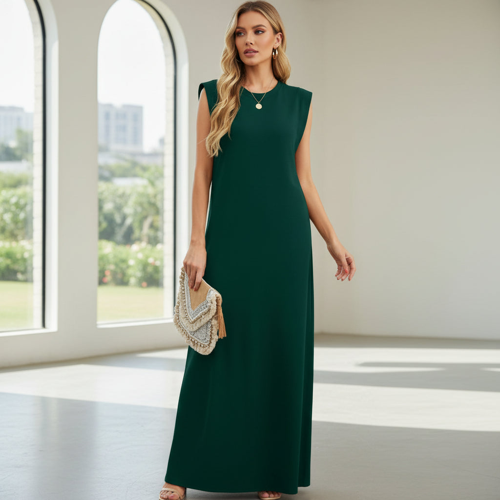 Woman wearing a green dress holding a beaded clutch on a white background