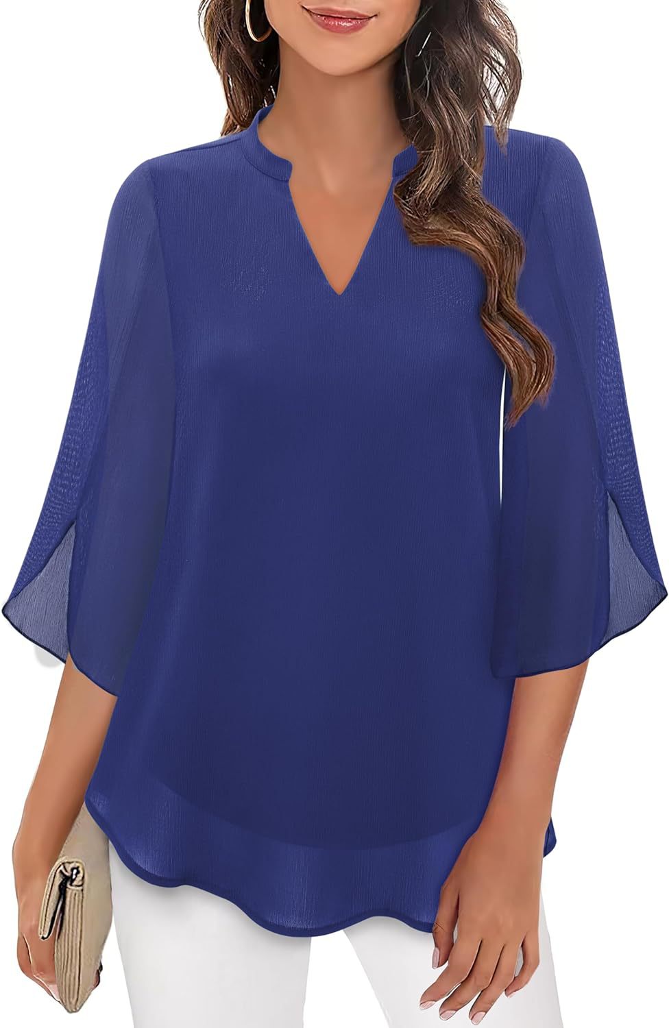 Woman wearing a blue blouse with sheer sleeves on a white background