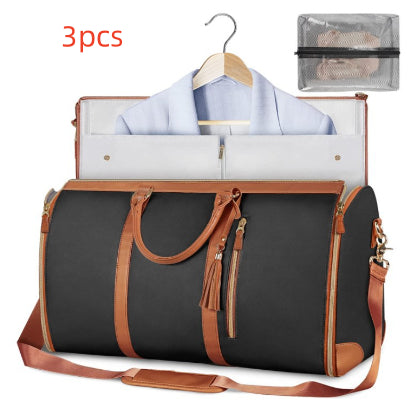 Black and brown travel bag with clothes on a hanger and a mesh pouch on a white background.