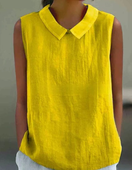 A bright yellow sleeveless linen blouse with a pointed collar, worn by a model.