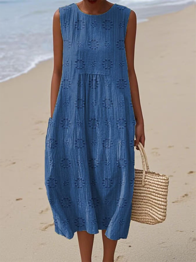 Woman wearing a blue dress on a beach
