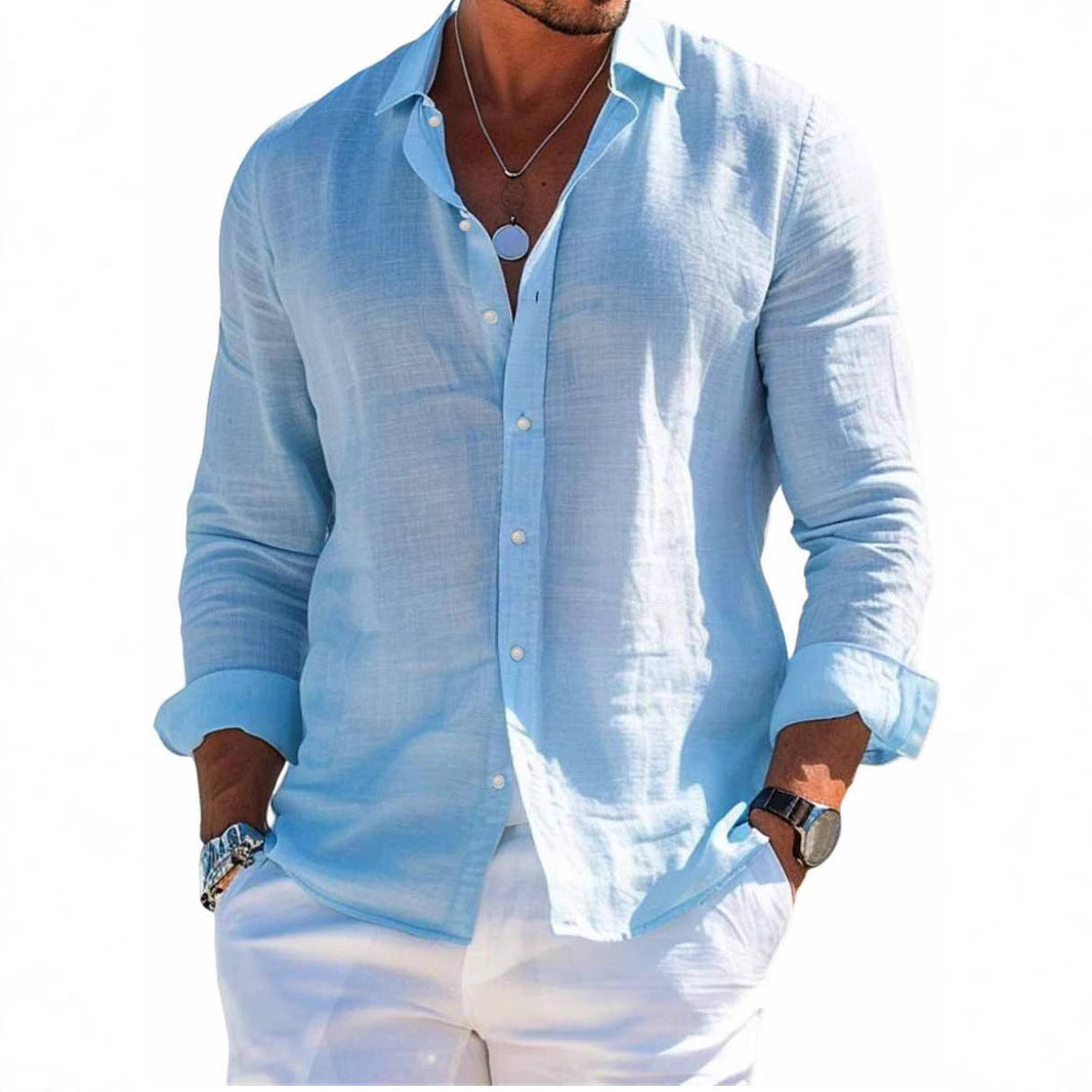 Man wearing a light blue linen shirt with rolled-up sleeves on a white background