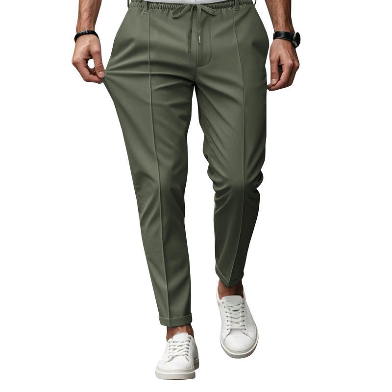 Green pants worn by a person on a white background
