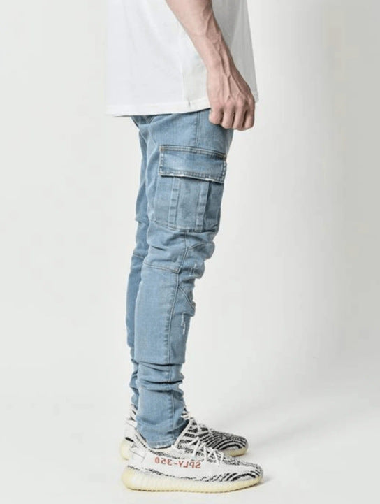 Person wearing light blue cargo pants and white sneakers on a plain background