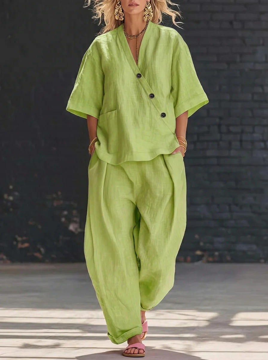 Person wearing a green outfit with a black brick wall background