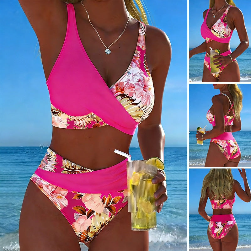 Woman in a pink floral bikini holding a drink at the beach