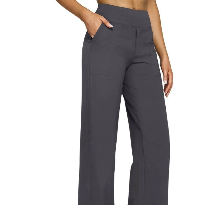 Dark gray pants worn by a person on a white background