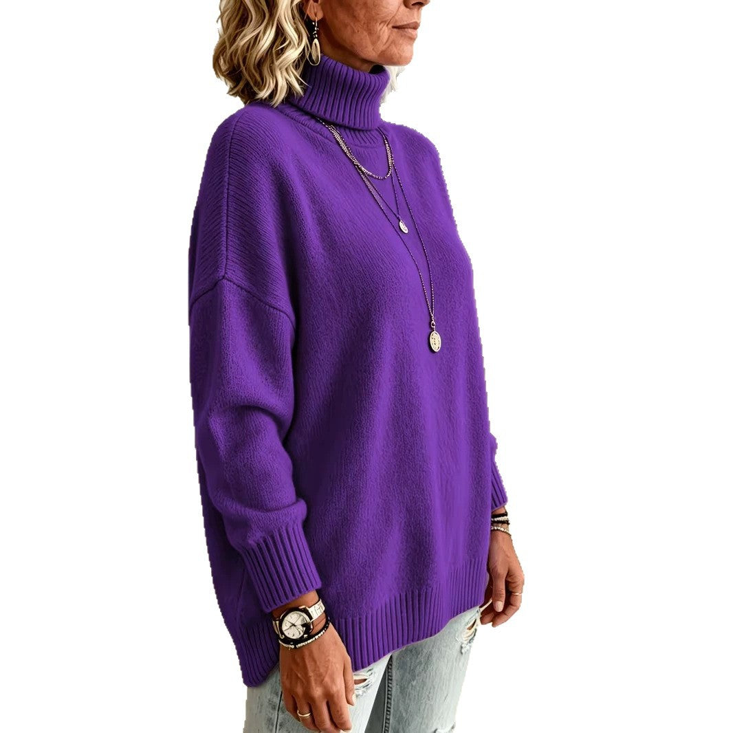A woman wearing a vibrant purple ribbed turtleneck sweater, styled with layered gold necklaces, bracelets, and a watch, paired with light-wash distressed jeans against a plain white background.