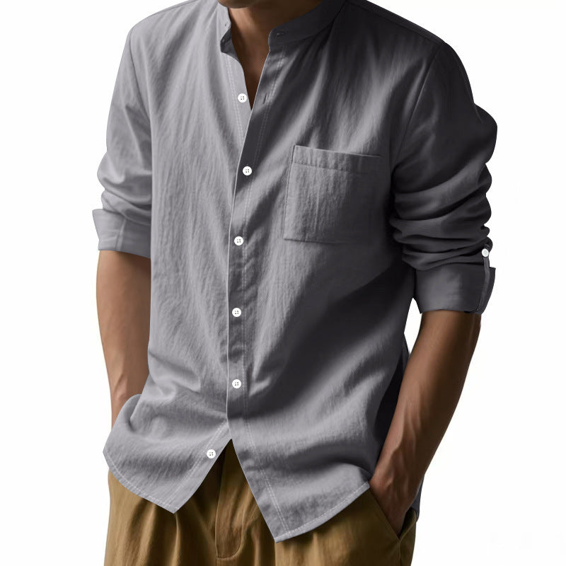 Gray button-up shirt worn by a person on a white background
