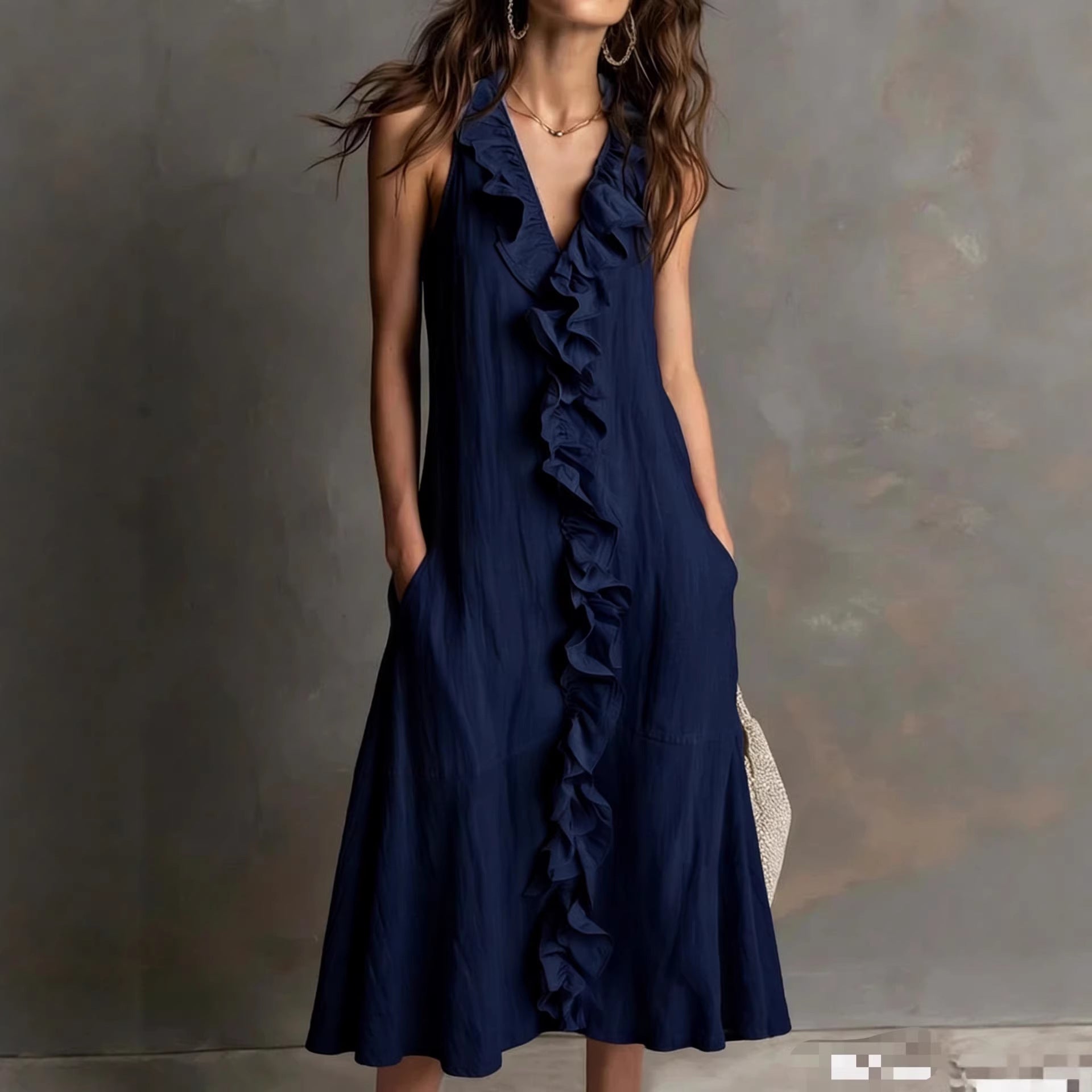 Navy blue ruffled dress worn by a model against a neutral background