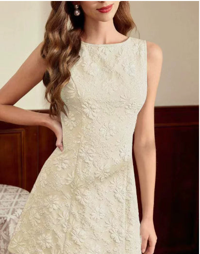 Woman wearing a light-colored lace dress with a neutral background