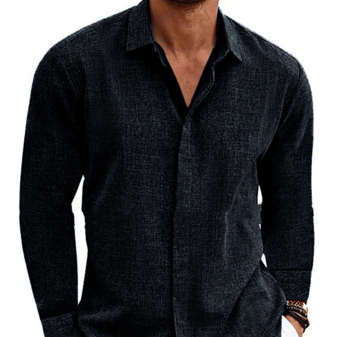 Dark gray button-up shirt worn by a person on a white background