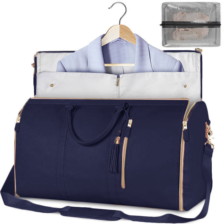 Navy blue travel bag with a white shirt on a hanger inside, a clear pouch with a black strap, and a mesh pouch.