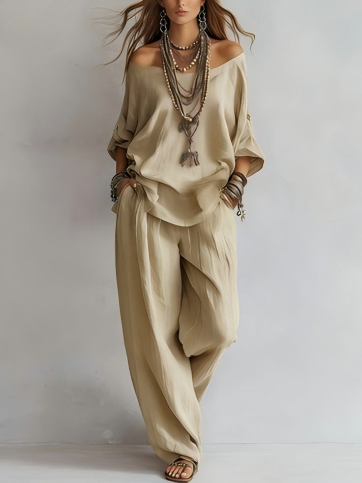 Beige outfit with wide-leg pants and off-shoulder top on a plain background