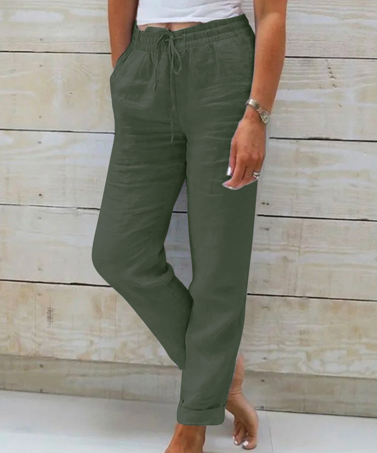 Person wearing green pants with a wooden background