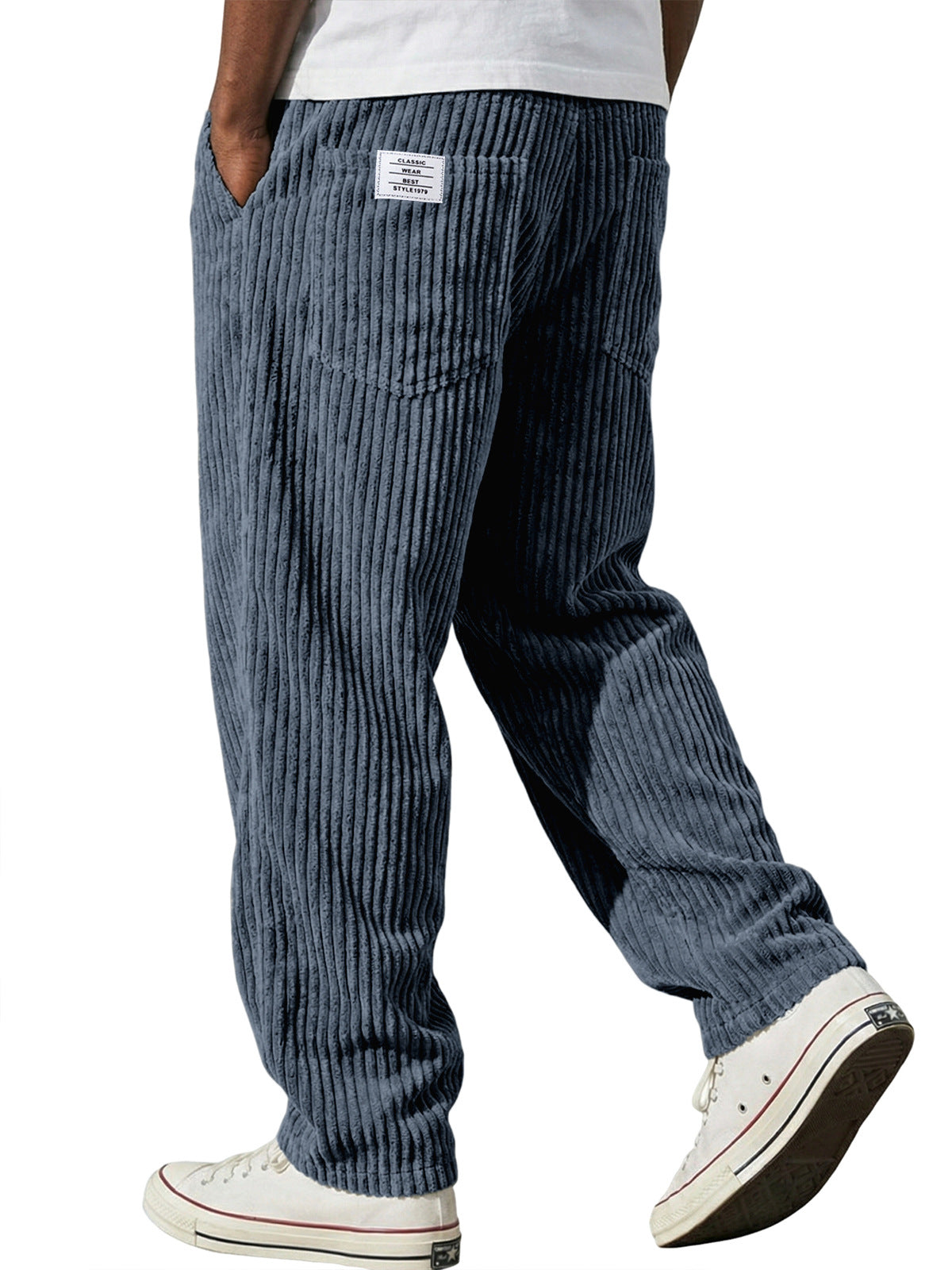 Blue corduroy pants worn by a person on a white background