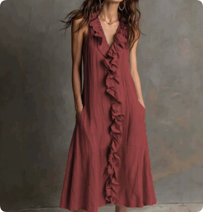 Red dress with ruffles on a textured gray background