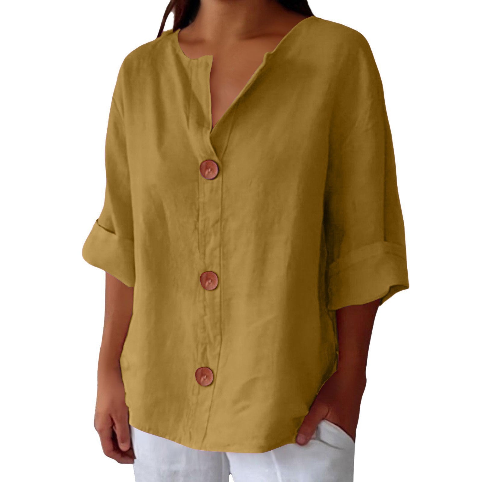 Yellow button-up shirt worn by a person on a white background