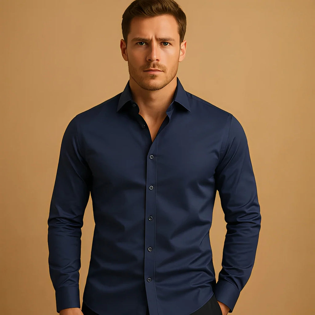 Man wearing a navy blue shirt against a beige background