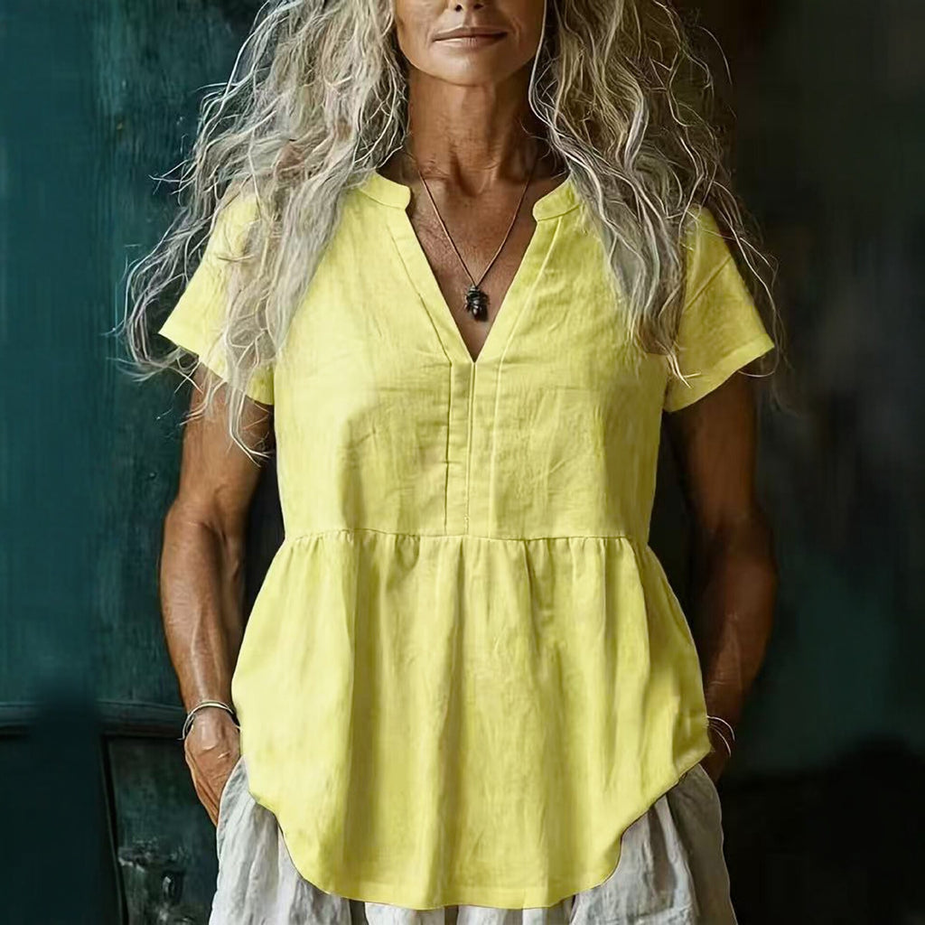 Woman wearing a yellow top with a blurred background