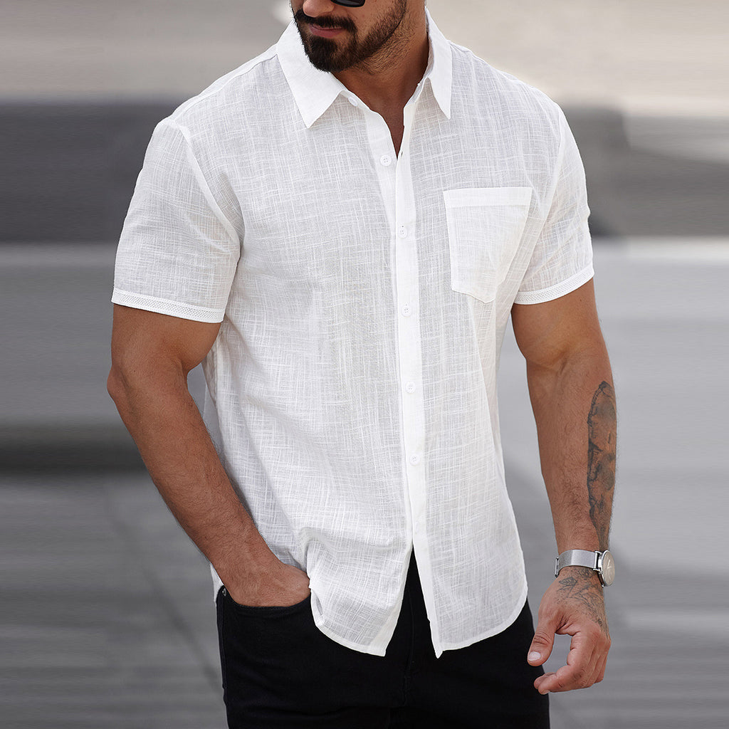Man wearing a white short-sleeve linen shirt with a blurred background