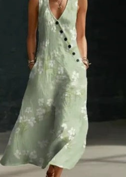Woman wearing a light green dress with black buttons on a dark background