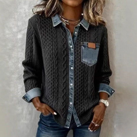 Person wearing a dark gray textured shirt with rolled-up sleeves and denim collar against a neutral background