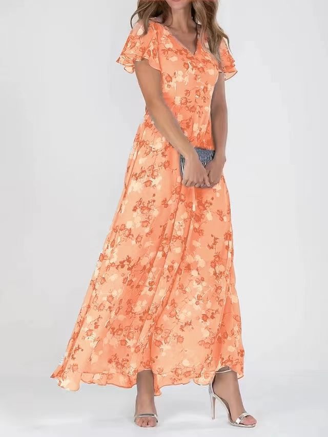 Woman wearing an orange floral dress on a white background