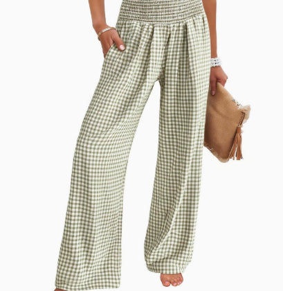 Person wearing green and white checkered pants on a white background